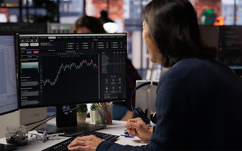 Professional trader monitoring real-time market data in Singapore office