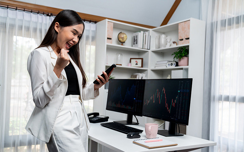 Confident trader celebrating successful stock trade on Wemastertrade