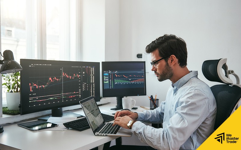 Focused trader analyzing stock charts to protect trading capital.