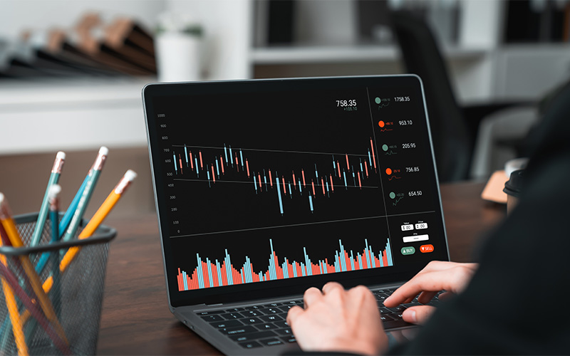 Trader executing consistent strategy using desktop stock market charts.